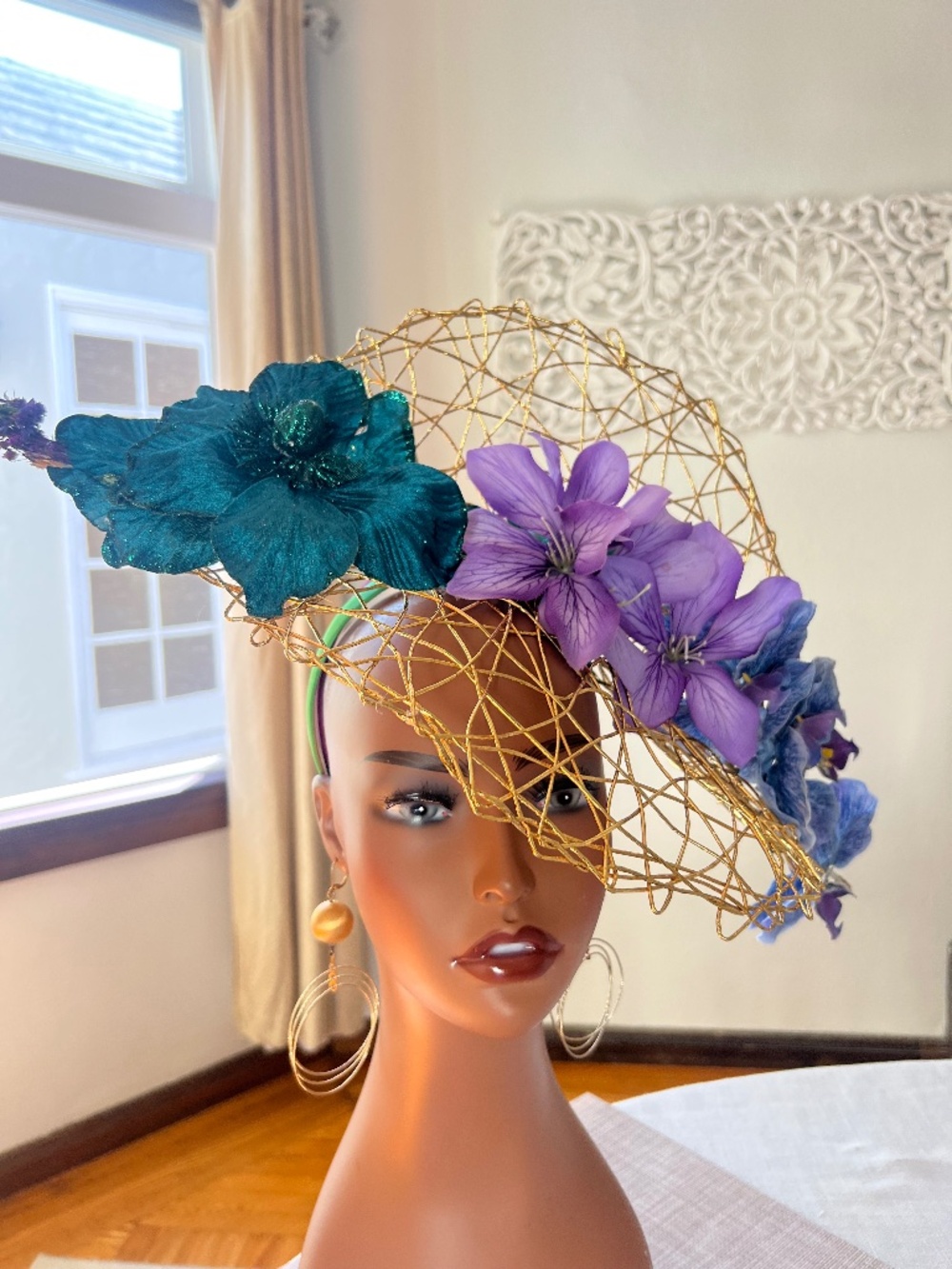 Green teal, purple flowers on a gold woven base fascinator